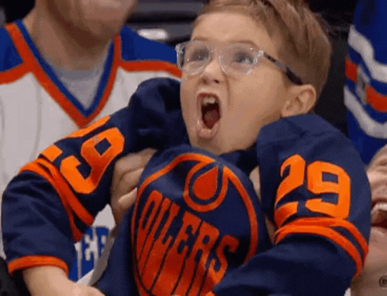 New years resolution: Little kid excited at an ice hockey game.
